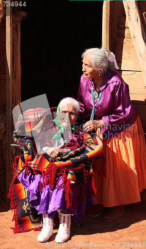 Image of Women in Front of Their Family Traditional Hogan Hut