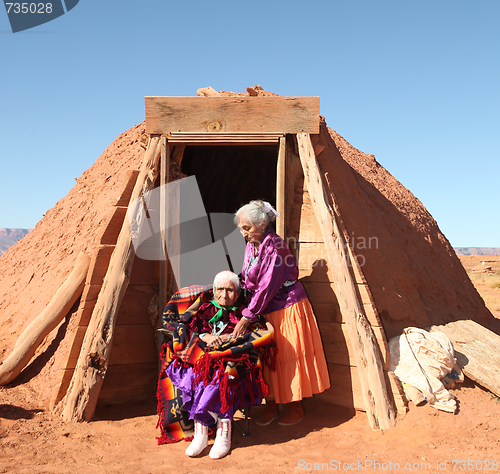 Image of 2 Navajo Women Outside Their Traditional Hogan Hut