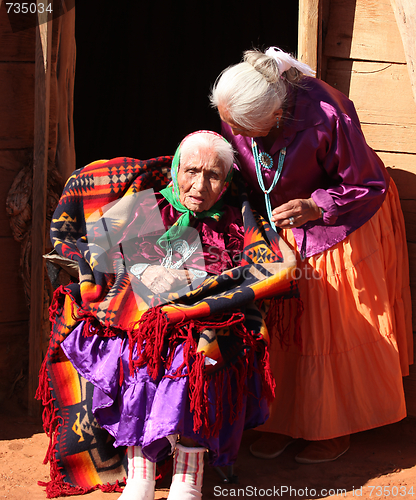 Image of Navajo Family of 2 Women in Front of Traditional Hogan