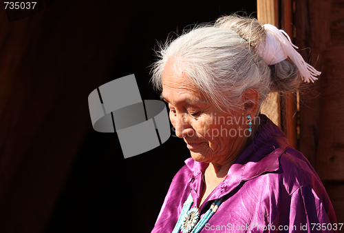 Image of A Navajo Woman Looking Down Outdoors in Bright Sun