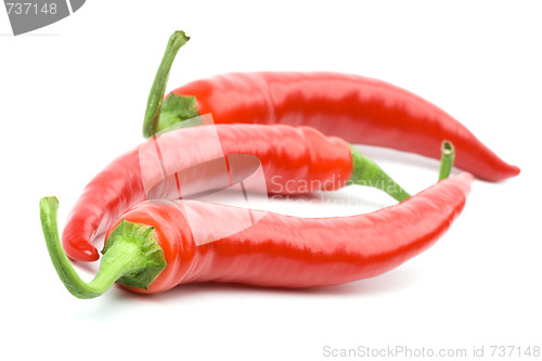 Image of three red chilly peppers