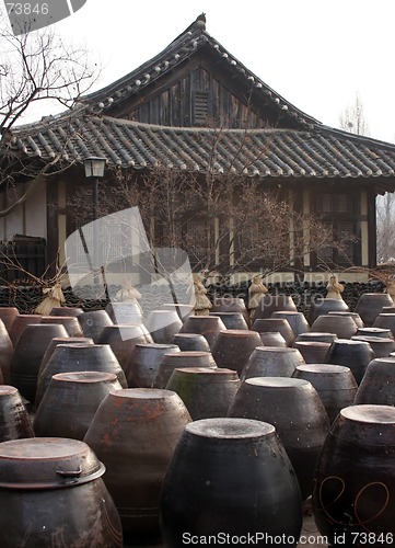 Image of Kimchi pots in front of a traditional Korean home