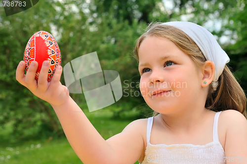 Image of Little girl holding Easter egg