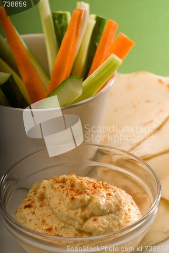 Image of hummus dip with pita bread and vegetable