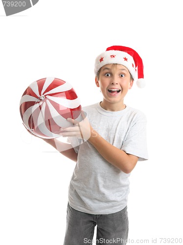 Image of Child boy holding Christmas bauble decoration