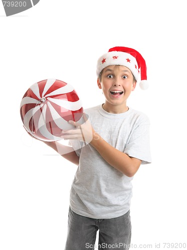 Image of Child boy holding Christmas bauble decoration