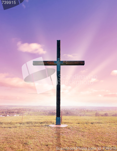 Image of cross of christ at sunset or sunrise
