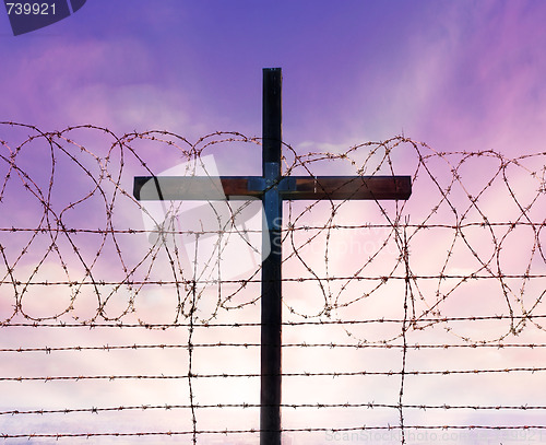 Image of cross of christ behind barbed wire