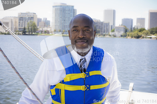 Image of Man in Life Vest on Sailboat