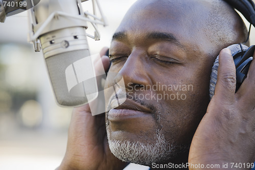 Image of Man in Front of Microphone