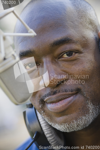 Image of Man with Microphone and Headphones