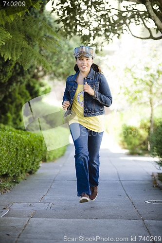 Image of Tween Girl Running On Sidewalk