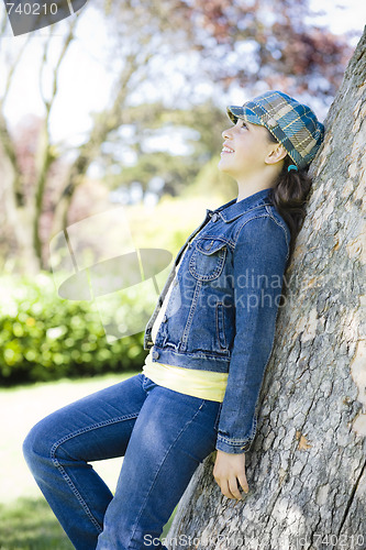 Image of Tween Girl Leaning Against Tree In Park