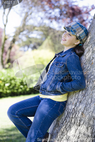 Image of Tween Girl Leaning Against Tree In Park