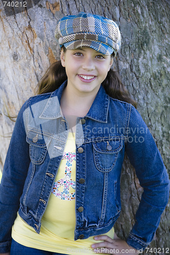 Image of Tween Girl Leaning Against Tree In Park