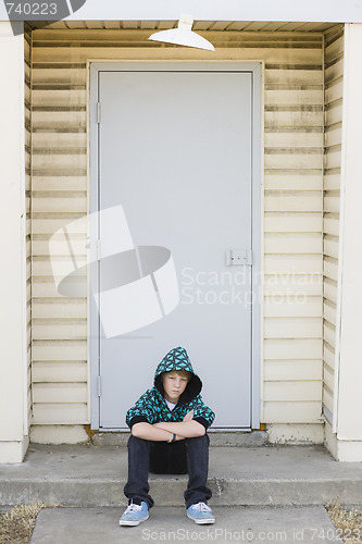 Image of Boy Sitting on a Curb