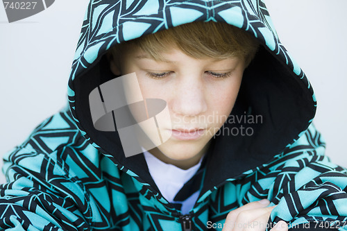 Image of Boy in Sweatshirt Looking Down