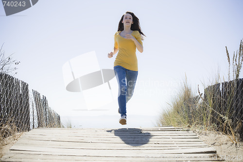 Image of Girl Running On Beach Walkway