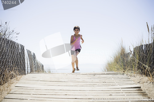 Image of Girl Running On Beach Walkway