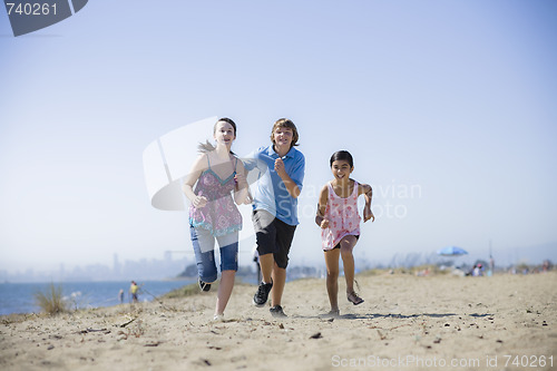 Image of Three Kids Running on Beach