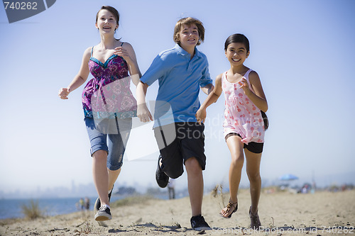 Image of Three Kids Running on Beach