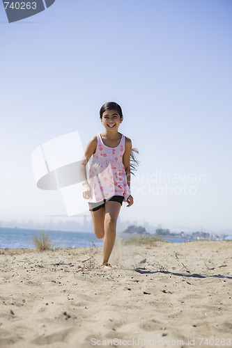 Image of Smiling Girl Running on beach