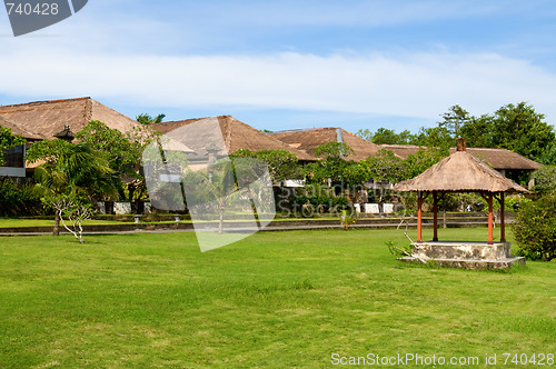 Image of Hut and villa over field