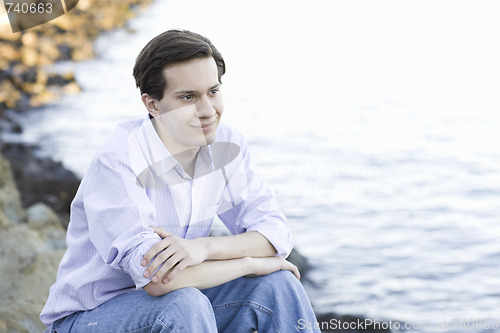 Image of Teenage Boy Sitting by Water