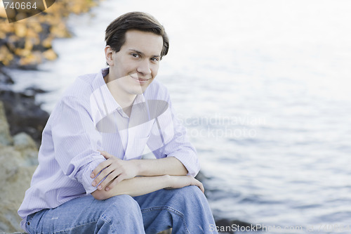 Image of Teenage Boy Sitting on Rocks