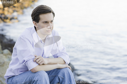 Image of Teenage Boy Sitting on Rocks