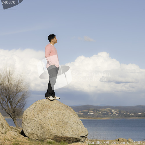 Image of Man Standing on Rock Looking into Distance 