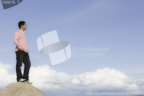 Image of Man Standing on Rock Looking into Distance