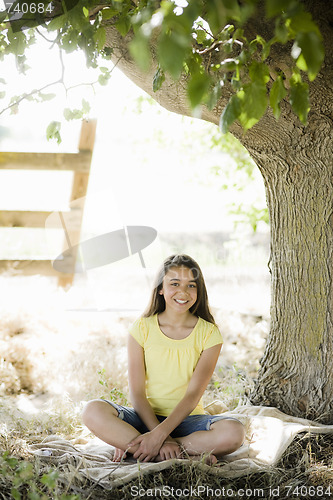 Image of Young Girl Sitting Under Tree