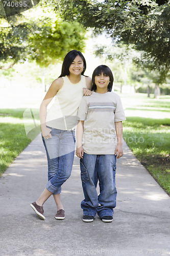 Image of Asian Brother and Sister Smiling To Camera