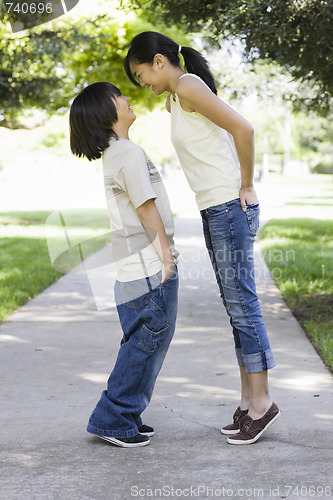 Image of Asian Brother and Sister Looking at each Other