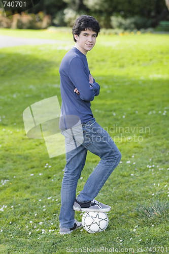 Image of Teenage Boy Standing On Soccer Ball