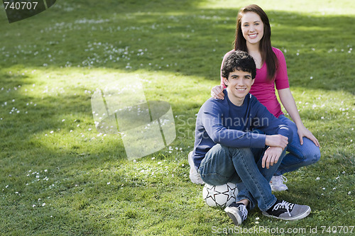 Image of Two Smiling Teenagers  with Soccer Ball