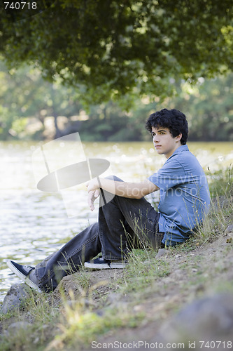 Image of Teen Boy Sitting By Lake