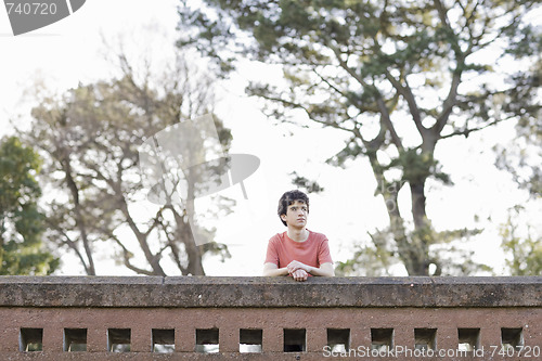 Image of Teen Boy Outdoors Looking Away From Camera