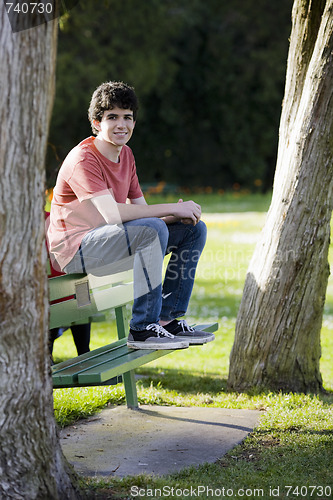 Image of Smiling Teenage Boy Sitting on Bench