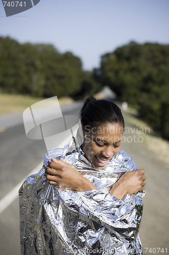 Image of Smiling Woman in Space Blanket 