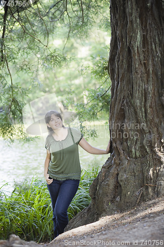 Image of Young Woman Standing by Tree
