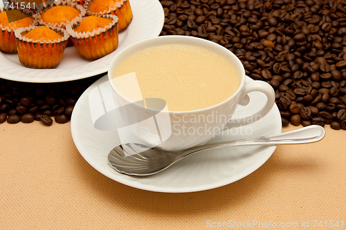 Image of White cup of coffee and coffee beans