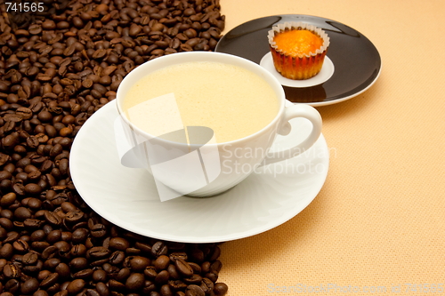 Image of White cup of coffee and coffee beans