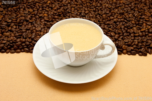 Image of White cup of coffee and coffee beans