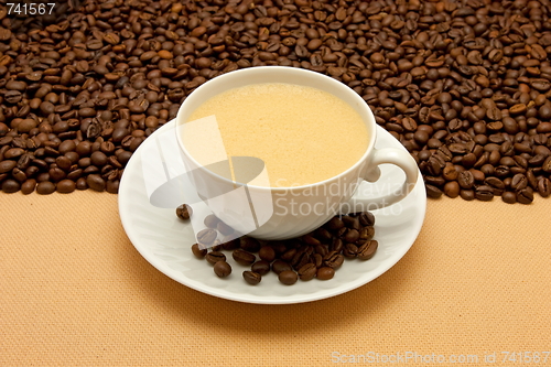 Image of White cup of coffee and coffee beans