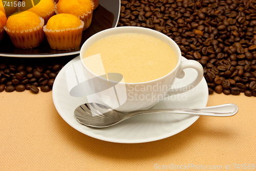 Image of White cup of coffee and coffee beans