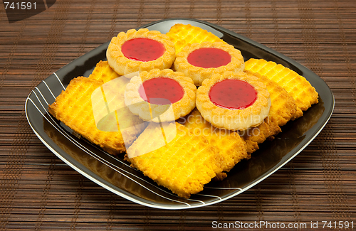 Image of plate of cookies on dark brown background
