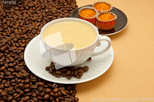 Image of White cup of coffee and coffee beans