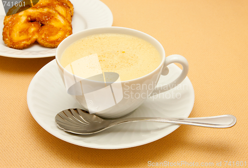 Image of Closeup of coffee with milk in white cup and a palmier pastry